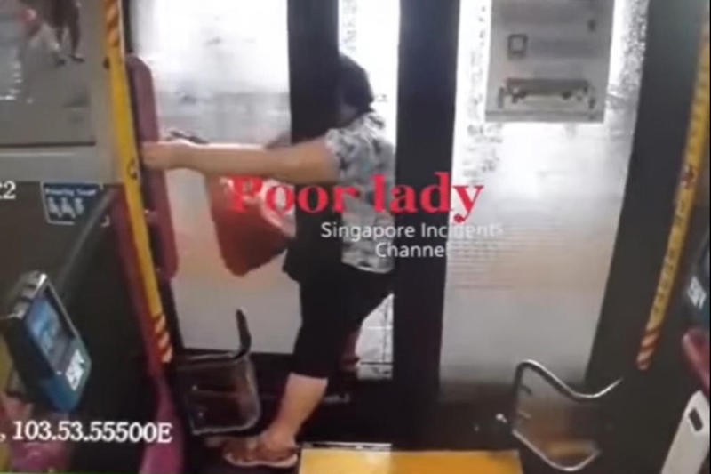 A screenshot of a video circulated on social media, which shows a woman losing her balance and falling backwards after bus doors close on her. u00e2u20acu201d Picture via Instagram/Singapore incidens