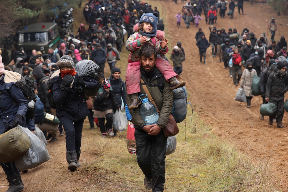 Migrants gather on the Belarusian-Polish border in an attempt to cross it at the Bruzgi-Kuznica Bialostocka border crossing, Belarus November 15, 2021. u00e2u20acu201d Reuters picnn