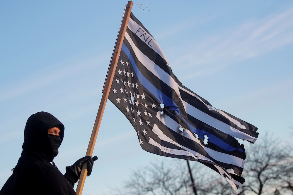 A protester stands outside The Kenosha County Courthouse, during the trial of Kyle Rittenhouse, in Kenosha, Wisconsin, November 15, 2021. u00e2u20acu201d Reuters picnn