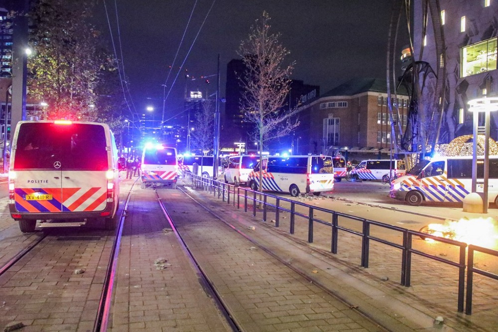 This photograph taken on November 19, 2021 shows police cars during a protest against the partial lockdown and against the 2G government policy in Rotterdam. u00e2u20acu201d AFP pic