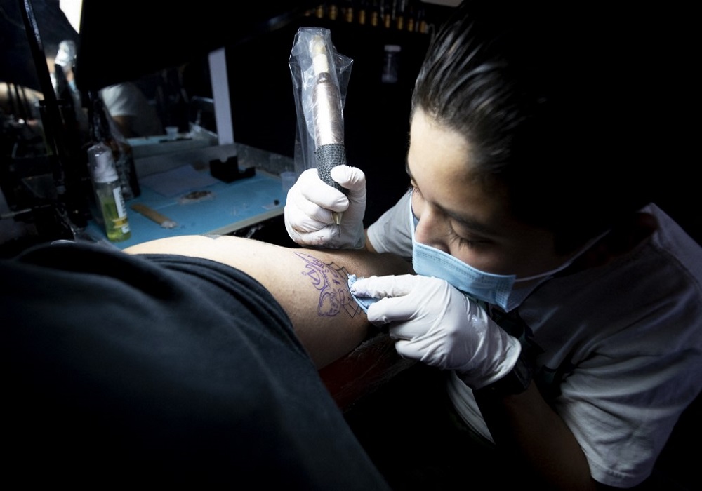 Brandon Burgos tattoos a person in the city of Puebla, state of Puebla, Mexico November 10, 2021. u00e2u20acu201d AFP pic