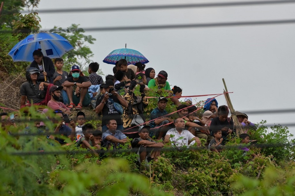 This picture taken on November 19, 2021 shows people looking on from a hill to watch a motorcycling race at the Mandalika International Circuit in Kuta Mandalika, Central Lombok. u00e2u20acu201d AFP pic