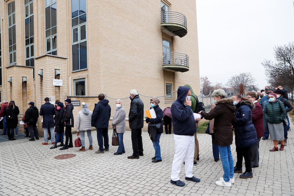 People stand in a queue for vaccination in front of a hospital as the spread of the coronavirus disease (Covid-19) continues, in Budapest, Hungary, November 22, 2021. u00e2u20acu201d Reuters picnn