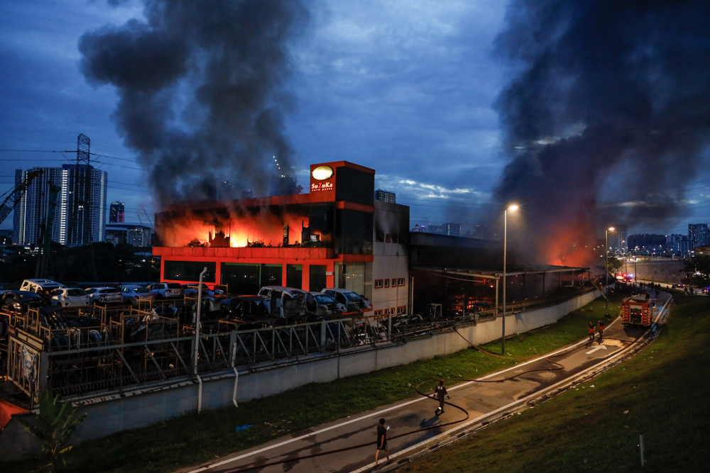 Fire and Rescue Department personnel putting out the fire at the auto part shop in Taman Segambut, November, 23, 2021. u00e2u20acu201d Picture by Firdaus Latif