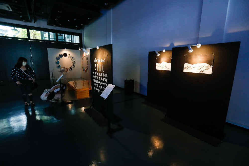 Visitors look at art installations during the 3 X 3 Group Exhibition in conjunction with the Georgetown Festival in Penang November 26, 2021. — Picture by Sayuti Zainudin