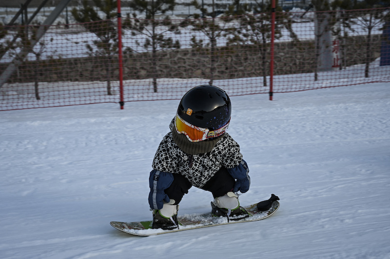 This photo taken on November 24, 2021 shows 11-month-old toddler Wang Yuji sliding down a slope on her snowboard at a ski resort in Zhangjiakou, in northern Chinau00e2u20acu2122s Hebei province. u00e2u20acu201d AFP pic