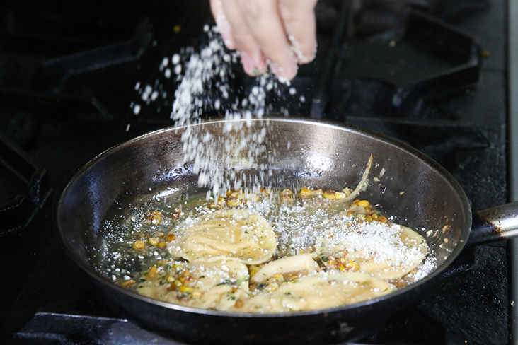 The 'entree' for the upcoming menu features handmade ravioli that is generously sprinkled with Parmesan cheese