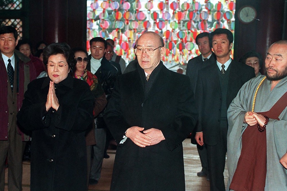 This file photo taken on December 30, 1997 shows former South Korean president Chun Doo-Hwan (centre), and his wife Lee Sun-Ja (left) starting a 100-day prayer at Seoulu00e2u20acu2122s Chogye temple. u00e2u20acu201d AFP picnn