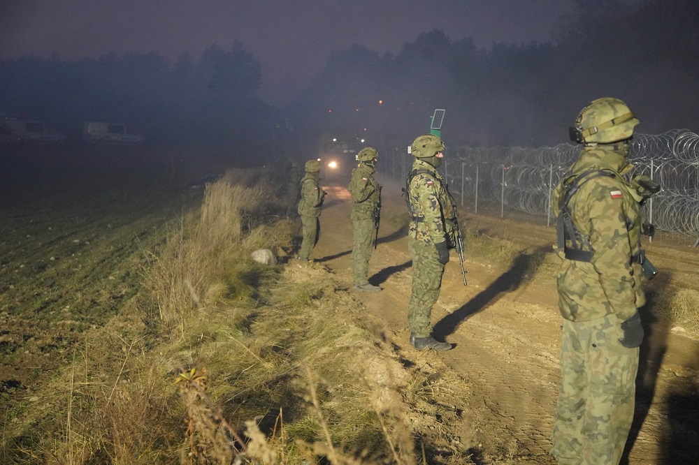 Polish soldiers stay on guard at Poland/Belarus border near Kuznica, Poland, in this photograph released by the Polish Ministry of Defence, November 11, 2021. u00e2u20acu2022 MON/Handout via Reuters
