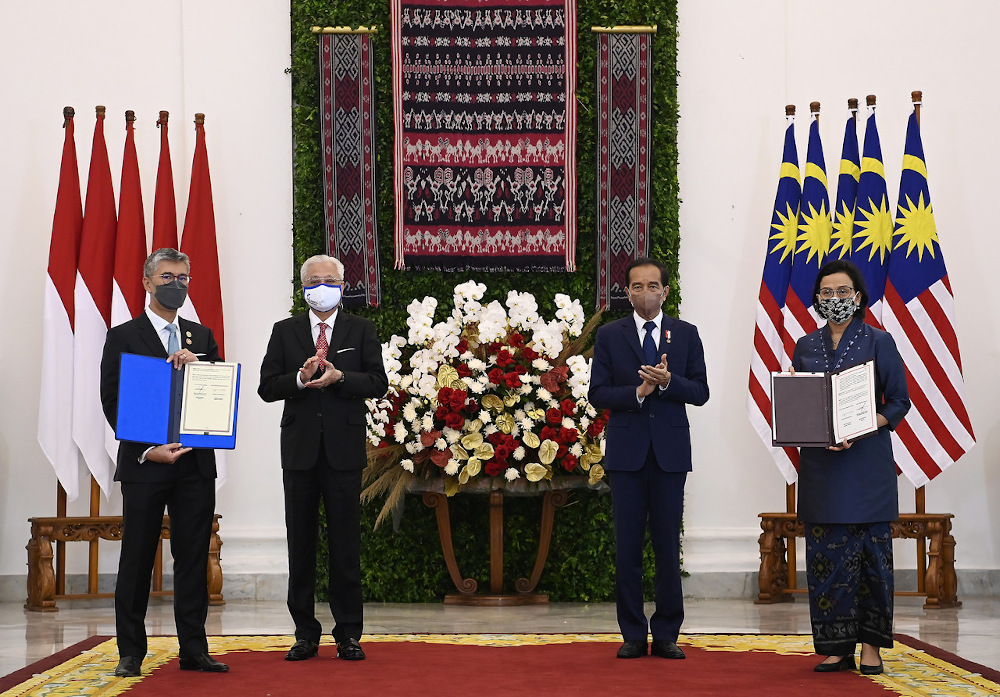 Prime Minister Datuk Seri Ismail Sabri Yaakob and Indonesian President Joko Widodo pose with Finance Minister Datuk Seri Tengku Zafrul Abdul Aziz and Indonesian Finance Minister Sri Mulyani Indrawati at the Bogor Palace November 11, 2021. u00e2u20acu201d Bernama pic