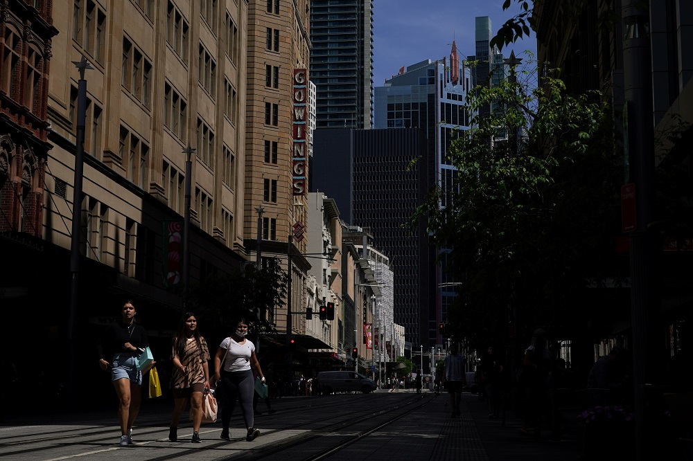 Pedestrians cross a street in the city centre, as the state of New South Wales surpasses the 90 per cent double-dose Covid-19 vaccination target for its population aged 16 and over, in Sydney, November 9, 2021. u00e2u20acu2022 Reuters pic