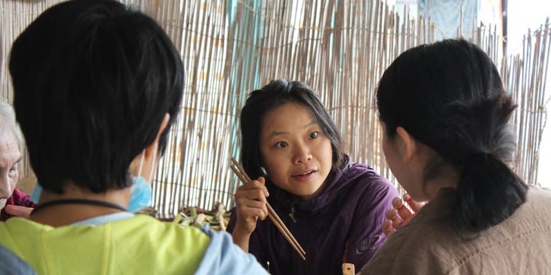Farmer Hu Siqin talking with neighbours during lunch in Chongming island in Shanghai. u00e2u20acu2022 ETX Studio picnn