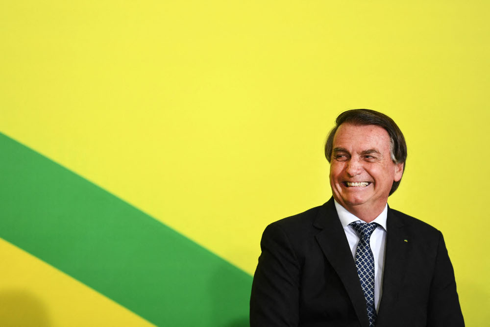 Brazilian President Jair Bolsonaro smiles during a ceremony for the signing of the consolidation of the new labour regulatory framework at the Planalto Palace in Brasilia, November 10, 2021. u00e2u20acu201d AFP pic 