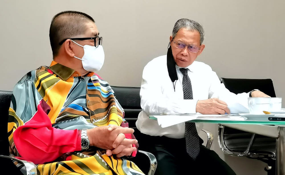 Datuk Seri Maximus Ongkili and Datuk Seri Mustapa Mohamed having a discussion during the meeting November 25, 2021. u00e2u20acu201d Borneo Post pic