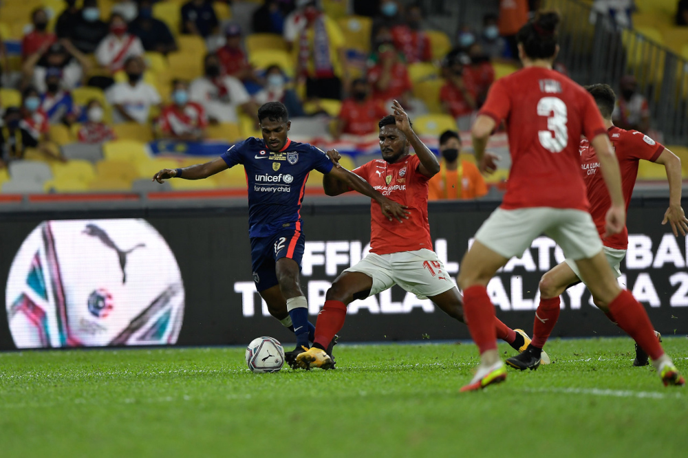 JDT’s Kunanlan Subramaniam in action with KL City’s Partiban K Janasekaran during the Malaysia Cup final at the Bukit Jalil National Stadium, November 30, 2021. — Bernama pic