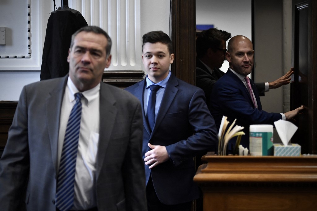 Kyle Rittenhouse, centre, enters the courtroom with his attorneys Mark Richards, left, and Corey Chirafisi for a meeting called by Judge Bruce Schroeder at the Kenosha County Courthouse on November 18, 2021 in Kenosha, Wisconsin. u00e2u20acu201d Getty Images via AFP