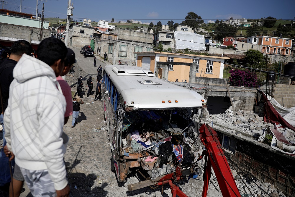 Government personnel work at the scene where at least 19 people were killed and 20 more injured after a passenger bus travelling on a highway crashed into a house in San Jose El Guarda, Mexico November 26, 2021. u00e2u20acu2022 Reuters pic