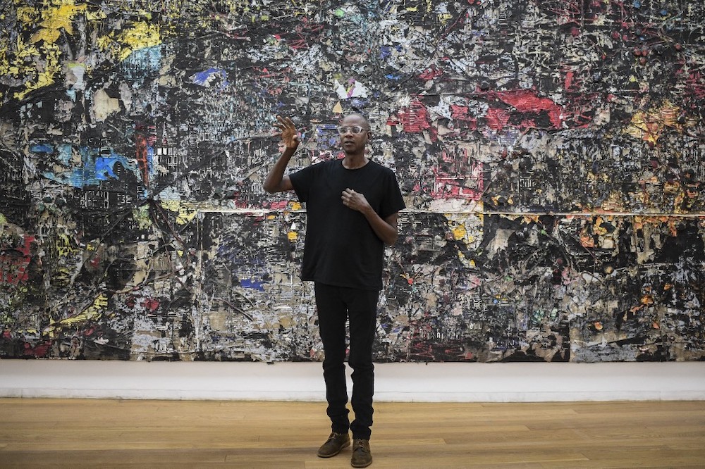US artist Mark Bradford talks during the presentation of his exhibition ‘AGORA’ at the Serralves Museum of Cotemporary art Art in Porto, north of Portugal, on November 25, 2021. — AFP pic