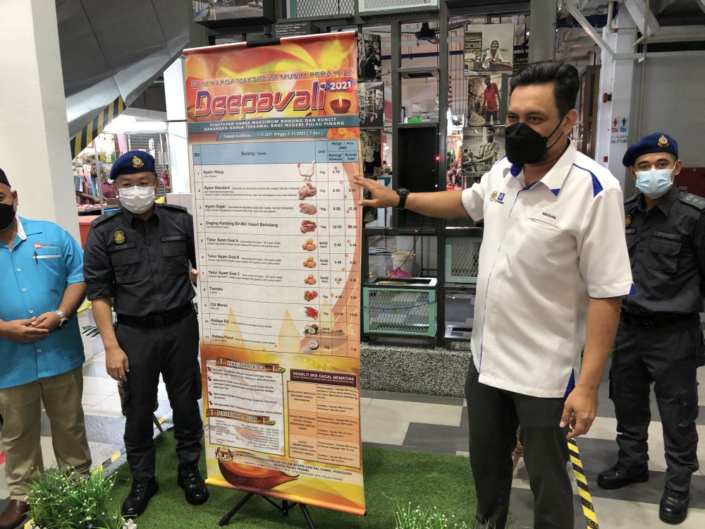 KPDNHEP Penang drector Mohd Ridzuan Ab Ghapar shows the list of 11 controlled price items for Deepavali season November 2, 2021. u00e2u20acu201d Picture by Opalyn Mok