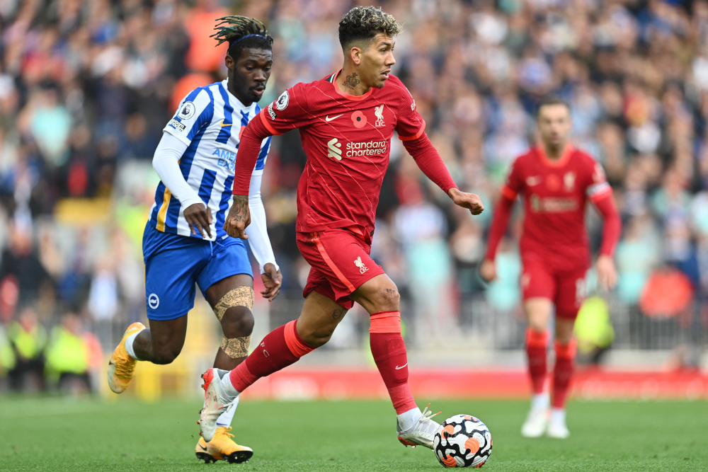 Liverpool midfielder Roberto Firmino vies with Brighton midfielder Yves Bissouma during the English Premier League match at Anfield in Liverpool, October 30, 2021. u00e2u20acu201d AFP picnn