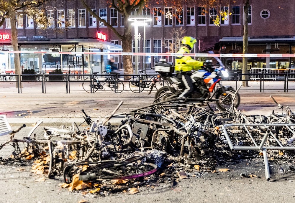 This photograph taken on November 20, 2021 shows burned bikes after a protest against the partial lockdown and against the 2G government policy in Rotterdam on November 19, 2021. u00e2u20acu2022 AFP picnn