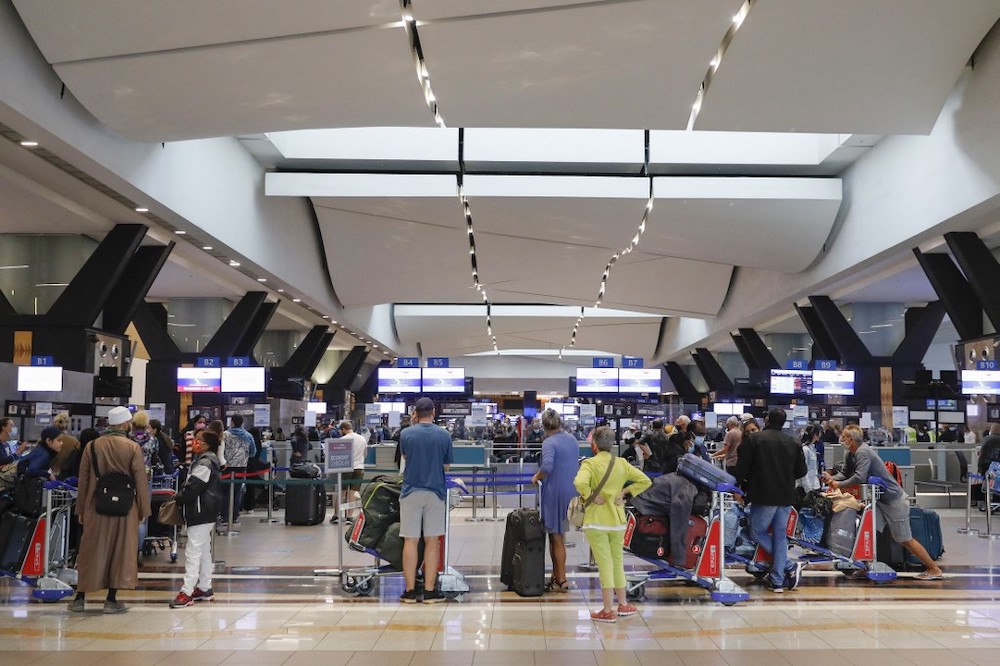 Travellers queue at a check-in counter at OR Tambo International Airport in Johannesburg on November 27, 2021, after several countries banned flights from South Africa following the discovery of a new Covid-19 variant Omicron. u00e2u20acu201d AFP picnn