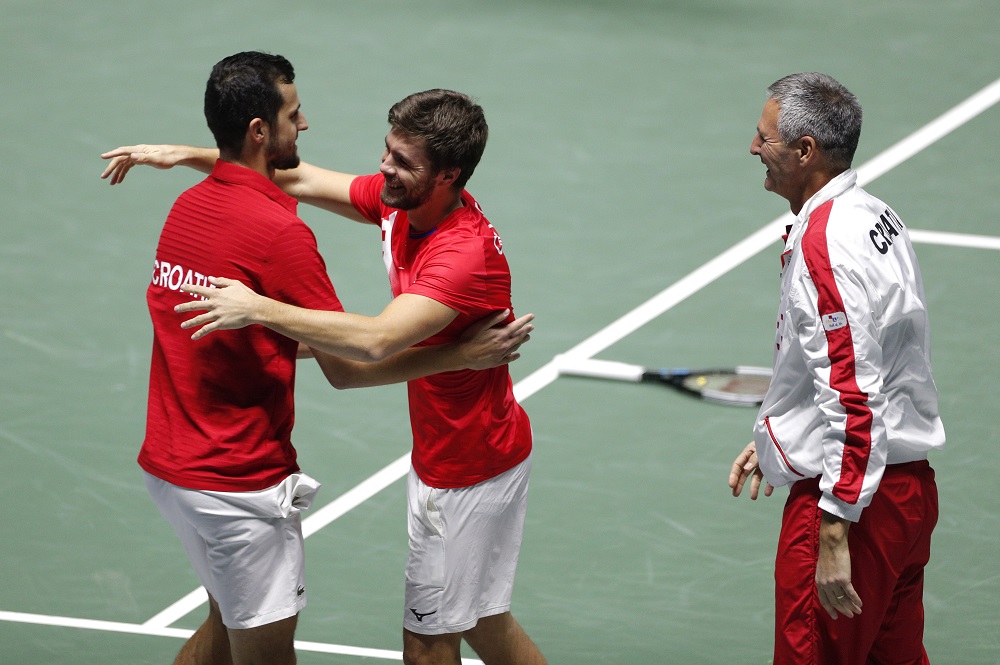 Croatia's Nikola Metic and Mate Pavic celebrate winning their match against Italy's Jannik Sinner and Fabio Fognini with Croatia captain Vedran Martic, November 29, 2021. u00e2u20acu2022 Reuters pic