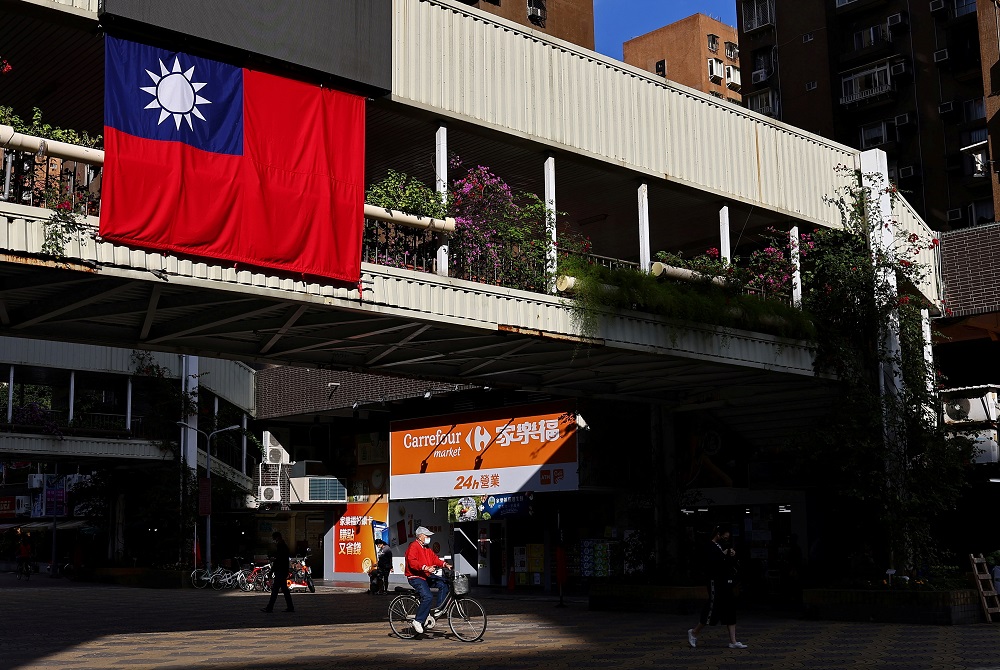 A man cycles past a Taiwan flag in Taipei, Taiwan November 16, 2021. u00e2u20acu2022 Reuters file pic
