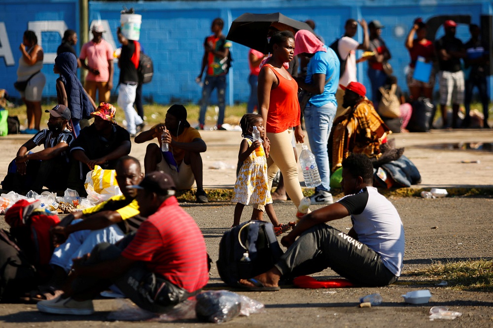 Migrants, mostly Haitians, wait outside a stadium to apply for humanitarian visas issued by Mexican authorities to be able to cross through Mexican territory to reach the US border, in Tapachula, Mexico November 24, 2021. u00e2u20acu2022 Reuters pic