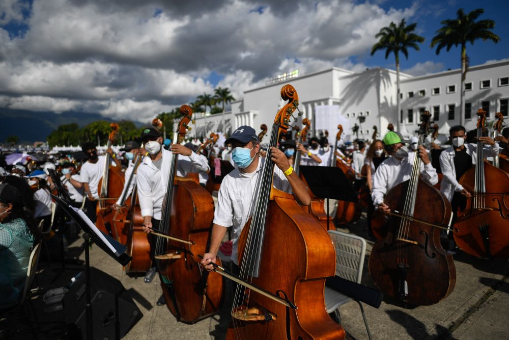 Members of the National System of Orchestras of Venezuela play during an attempt to enter the Guinness Book of Records for the largest orchestra in the world, with more than 12,000 musicians, in Caracas November 13, 2021.u00e2u20acu201d AFP picnn
