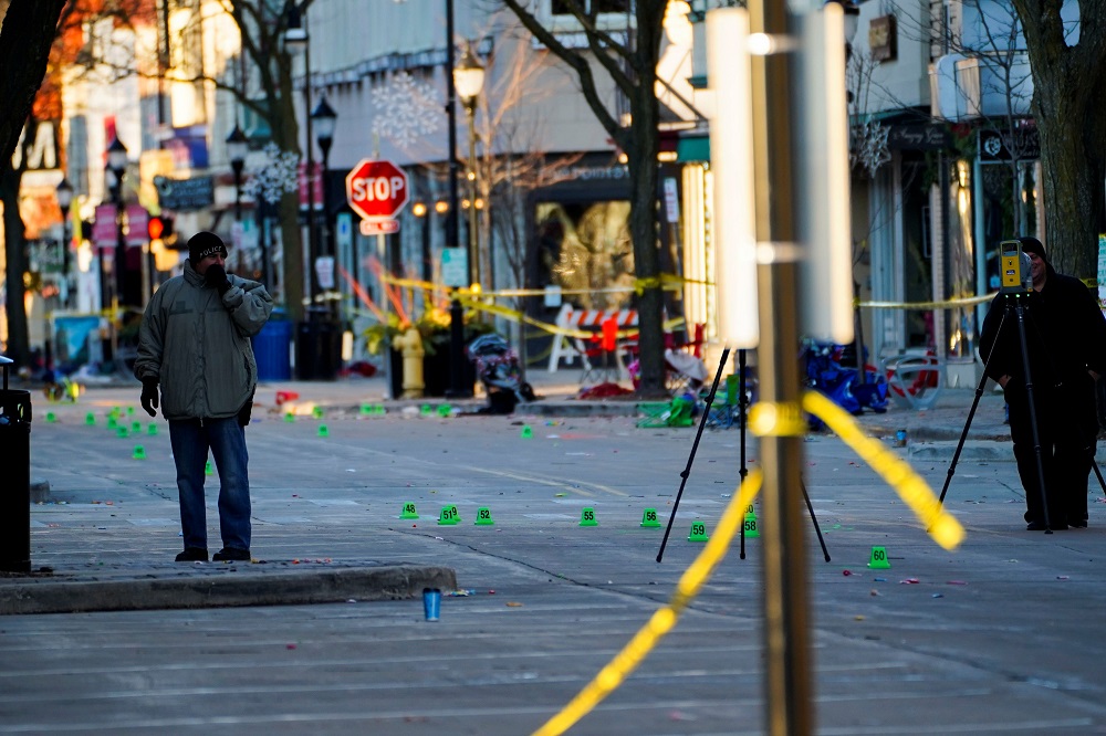 Police officers document marked evidence on Main Street the morning after a car plowed through a holiday parade in Waukesha, Wisconsin November 22, 2021. u00e2u20acu2022 Reuters pic