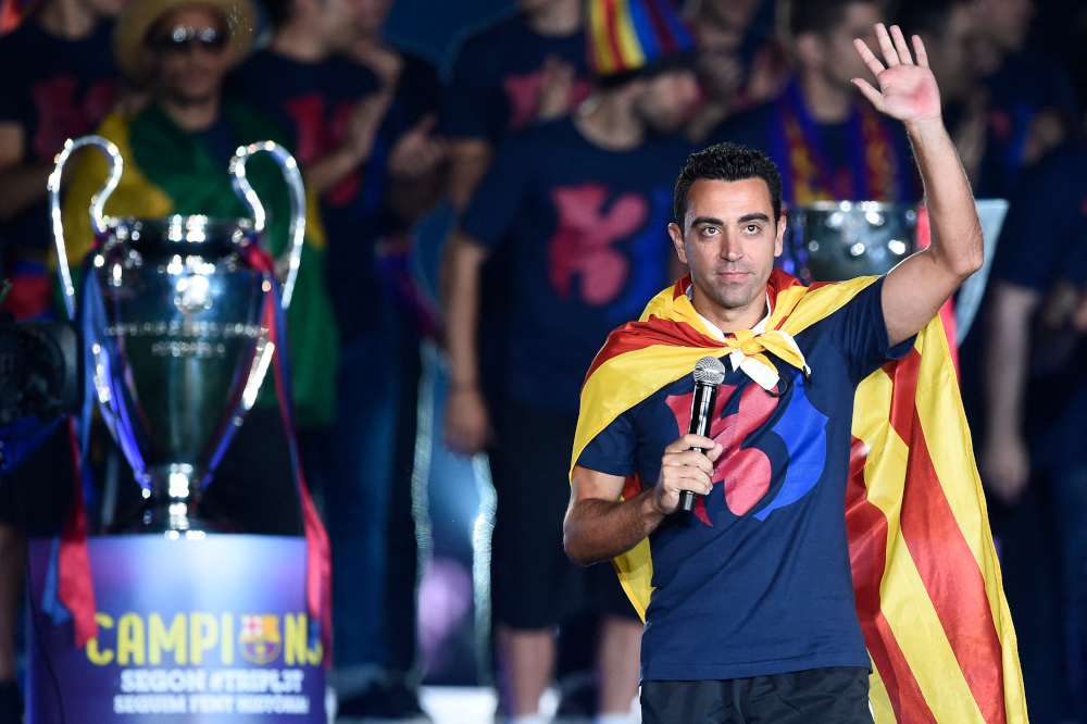 Barcelonau00e2u20acu2122s midfielder Xavi Hernandez waves as he takes part in the celebrations held for their victory over Juventus, one day after the Uefa Champions League final football, at the Camp Nou stadium in Barcelona, June 8, 2015. u00e2u20acu201d AFP pic 