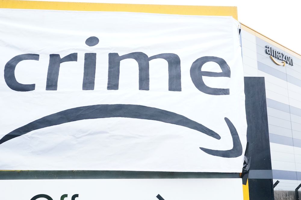 A banner hung by activists from Extinction Rebellion blocking the entrance to the Amazon fulfilment centre in Tilbury, Essex, preventing lorries from entering or leaving on Black Friday, the global retail giant's busiest day of the year. u00e2u20acu201d PA via Reuter