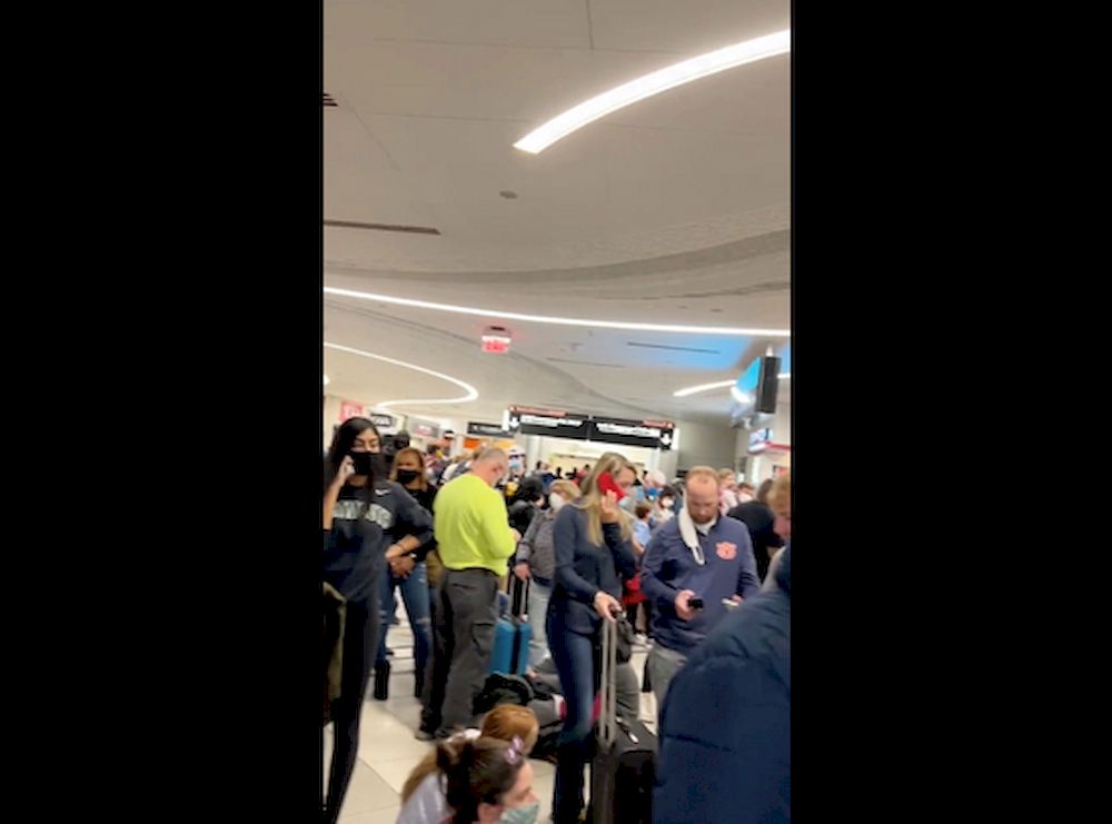 People gather to leave Hartsfield-Jackson Atlanta International Airport after reported shooting, in Atlanta, Georgia, US, November 20, 2021, in this still image obtained from a social media video. Twitter/mohiterajas/via Reuters