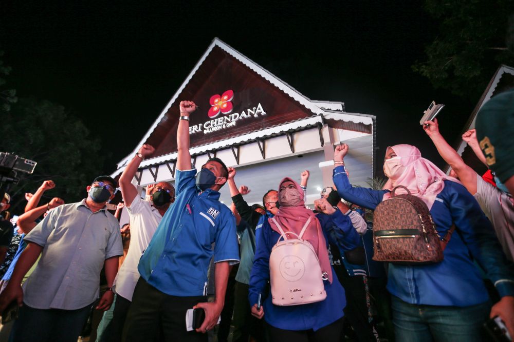 Barisan Nasional supporters celebrate a win for the coalition during the Melaka state election vote count at Dewan Seri Chendana, Ayer Keroh November 20, 2021. u00e2u20acu2022 Picture by Ahmad Zamzahuri