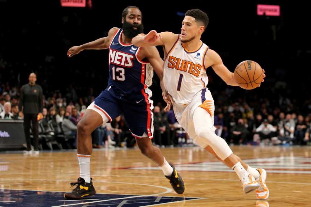 Phoenix Suns guard Devin Booker (1) drives to the basket around Brooklyn Nets guard James Harden (13) during the first quarter at Barclays Centre, Brooklyn November 27, 2021. u00e2u20acu201d Reuters pic