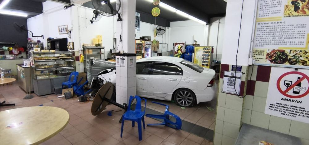 The car is seen inside the coffeeshop. u00e2u20acu201d Picture via Borneo Post