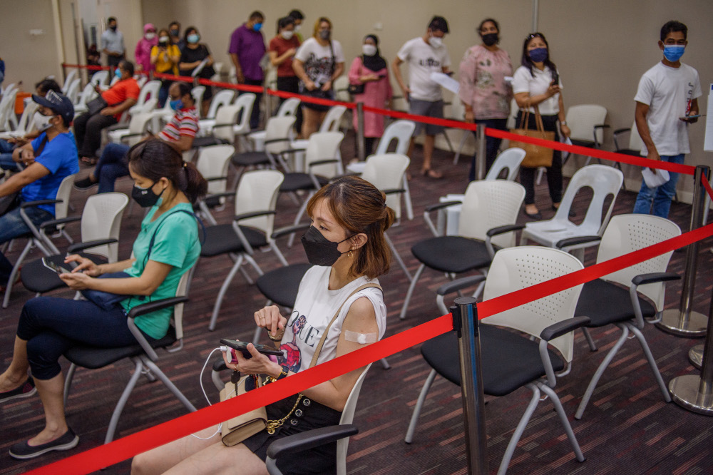 People wait to receive their Covid-19 booster jabs at the UEM Learning Centre in Petaling Jaya, November 24, 2021. u00e2u20acu201d Picture by Shafwan Zaidon     