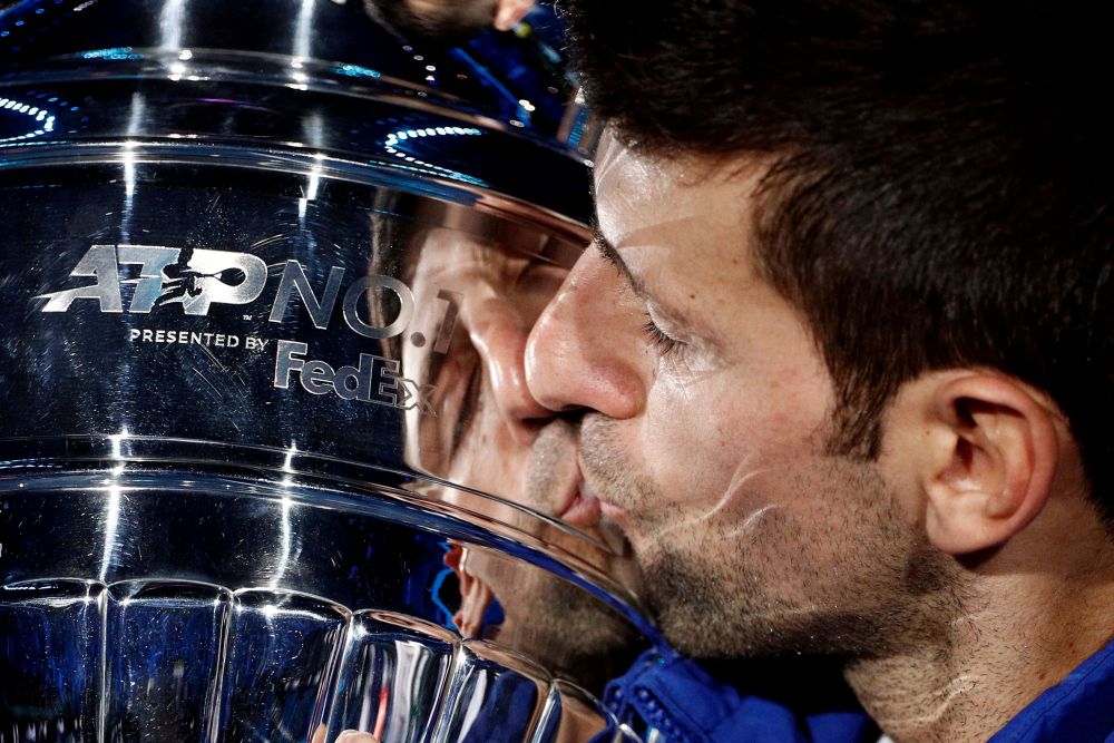 Serbia's Novak Djokovic kisses the trophy as he celebrates his 2021 world number one ranking after winning his group stage match against Norway's Casper Ruud in Turin November 15, 2021. u00e2u20acu201d Reuters picnn