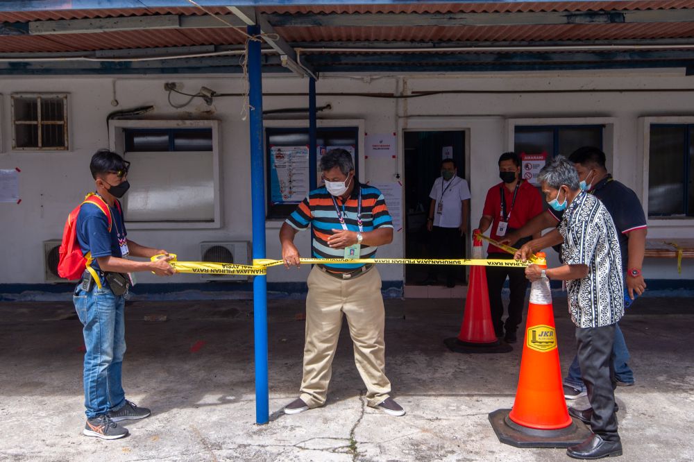 Election Commission personnel get the polling station at the Masjid Tanah police station ready ahead of early voting in Melaka November 15, 2021. u00e2u20acu201d Picture by Shafwan Zaidon