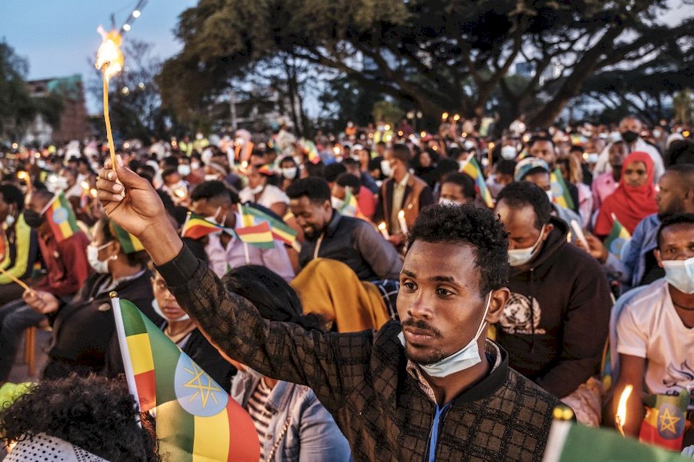 A man holds a candle during a memorial service for the victims of the Tigray conflict organized by the city administration, in Addis Ababa, Ethiopia, on November 3, 2021. u00e2u20acu201d AFP pic
