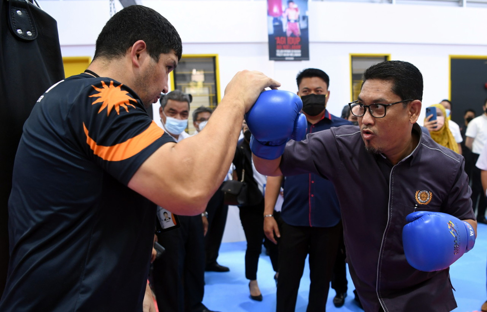 Youth and Sports Minister Datuk Seri Ahmad Faizal Azumu tries boxing at the launch of the Nilai NSC Complex, November 30, 2021. u00e2u20acu201d Bernama pic 