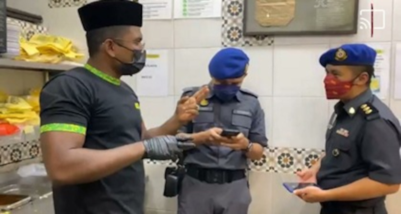 Officers from  Penang Domestic Trade and Consumer Affairs Ministry talking to Hameediyah restaurant director Muhammad Riyazz Syed Ibrahim earlier today. u00e2u20acu201d Picture courtesy of Penang Domestic Trade and Consumer Affairs Ministry