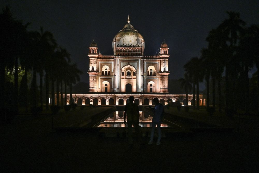 Visitors walk near the illuminated Safdarjung Tomb in New Delhi. u00e2u20acu201d  AFP pic