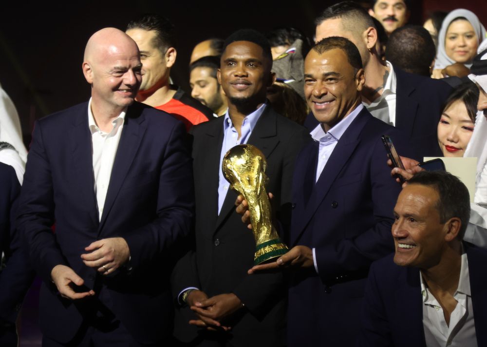 Fifa president Gianni Infantino (left) and former players Samuel Eto'o and Cafu pose with the World Cup in Doha November 21. 2021. u00e2u20acu201d Reuters picnn