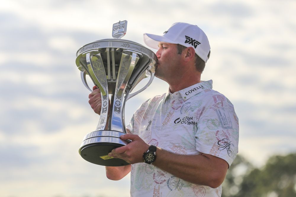 Jason Kokrak celebrates with the trophy after winning the 2021 Houston Open November 14, 2021. u00e2u20acu201d Reuters picn