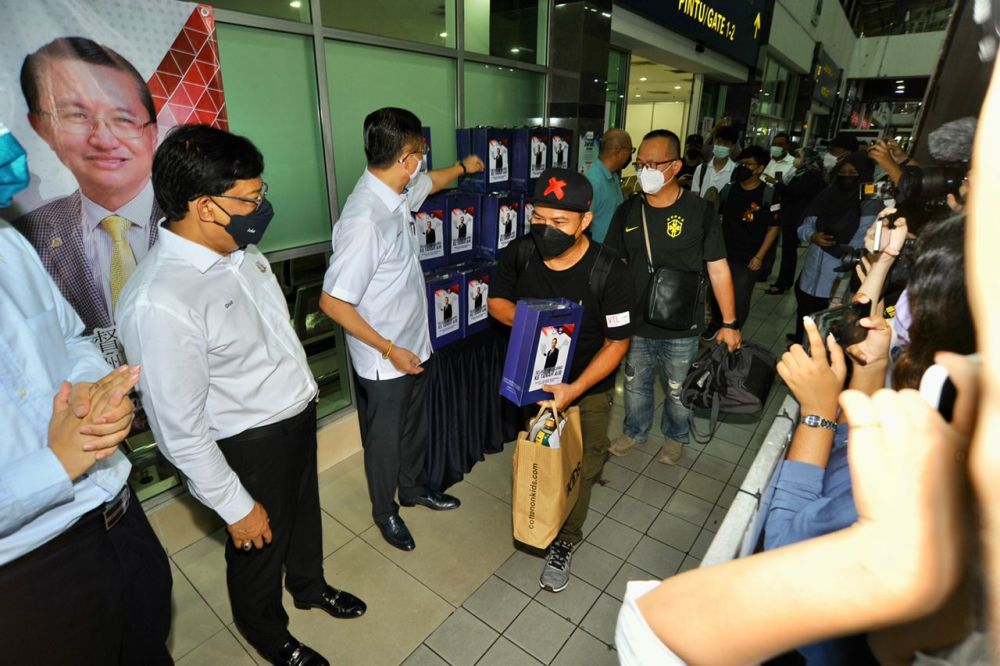 Malaysian Bali Jalang (centre) is greeted by Datuk Tee Siew Keong (third from left) upon his arrival at the Larkin Sentral Bus Terminal November 29, 2021. u00e2u20acu201d Picture by Ben Tan