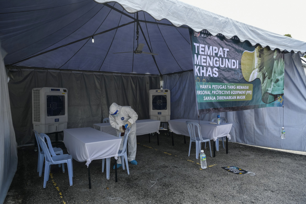 Cleaning staff carry out sanitation work at a polling station ahead of the early voting day for the Melaka 2021 state election, November 15. u00e2u20acu201d Bernama pic 