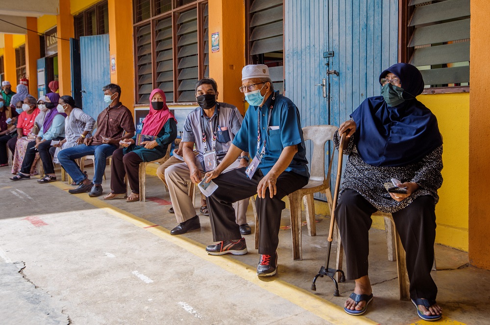 Senior citizens queue up to cast their votes in Durian Tunggal during the Melaka state election on November 20, 2021. u00e2u20acu2022 Picture by Shafwan Zaidon
