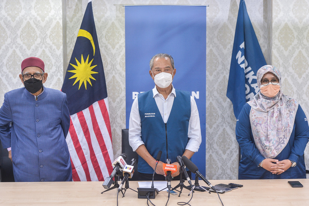 Perikatan Nasional chairman Tan Sri Muhyiddin Yassin with Datuk Mas Ermieyati Samsudin and PAS president Datuk Seri Abdul Hadi Awang at PN headquarters, Kuala Lumpur, November 18, 2021. u00e2u20acu201d Picture by Miera Zulyana